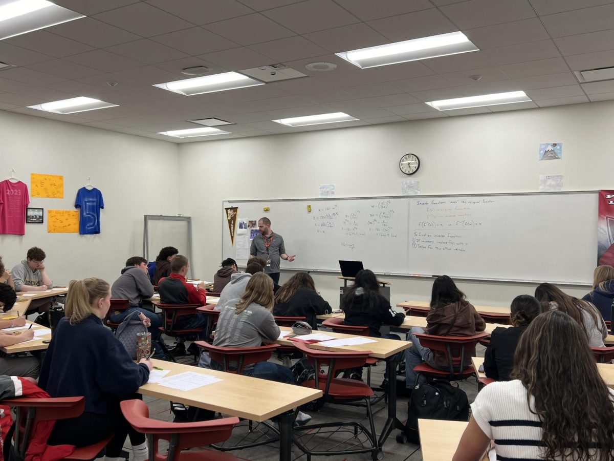 Students listen and take notes as Caleb Grim, math teacher at Portage High School, teaches one of his advanced classes.